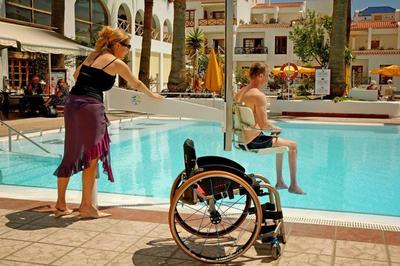 Family using pool hoist in accessible hotel in Tenerife