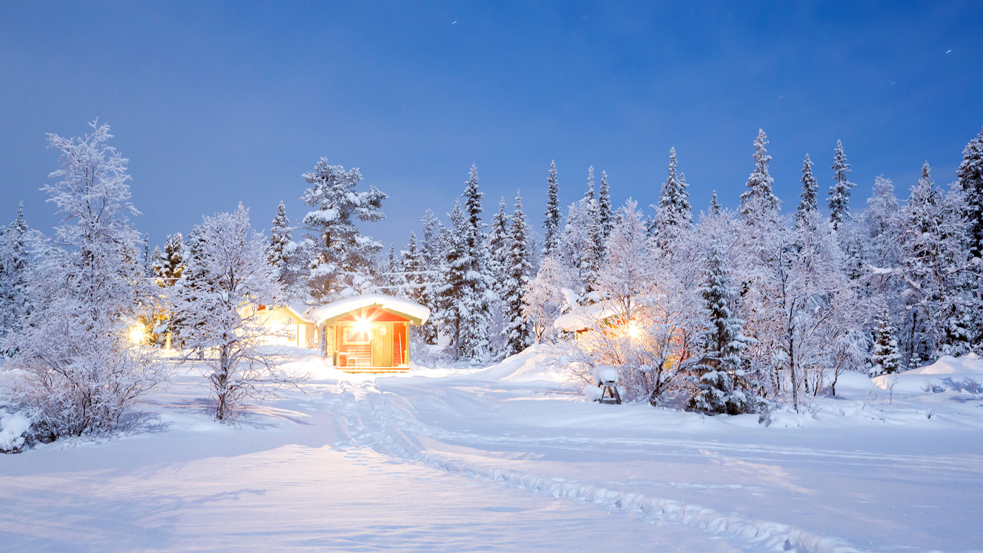Wooden cottages in winter snow, Lapland, Sweden
