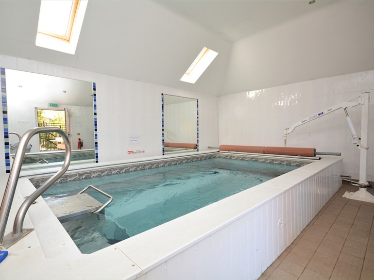 Swimming pool and hoist at accessible single-storey cottage in Cornwall