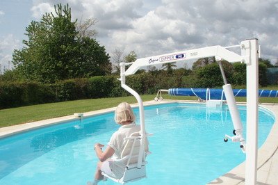 Guest using a pool hoist chair at accessible farmhouse in Normandy