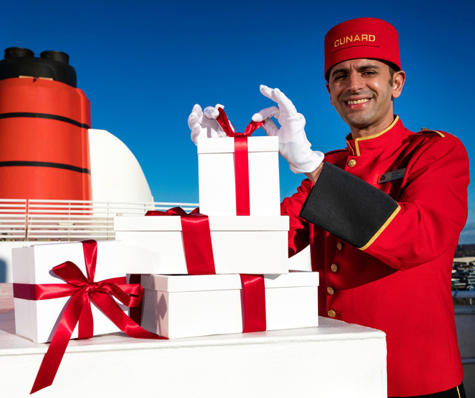 Bellboy with Christmas presents on a Cunard cruise