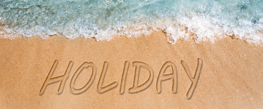 Holiday written on the beach