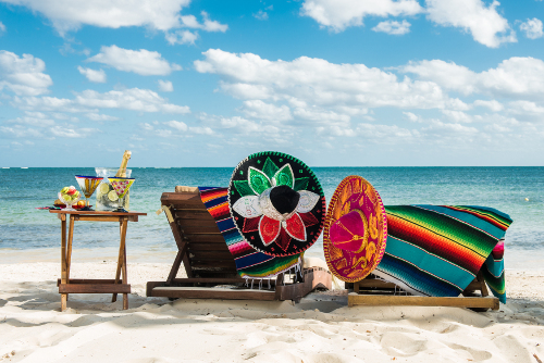 Mexican hats on sun loungers on stunning beach