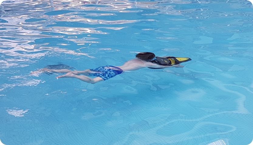 Child using the AquaJet in a swimming pool at a Haven holiday park