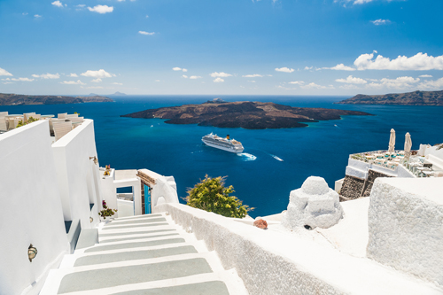 Cruise ship viewed from the white buildings of Santorini, Greece