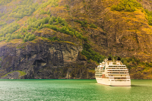 A cruise ship sailing through the Norwegian fjords