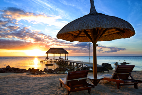 Deck chairs on the beach in Mauritius at sunset