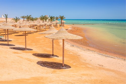 Parasols on sandy Hurghada beach, Read Sea, Egypt