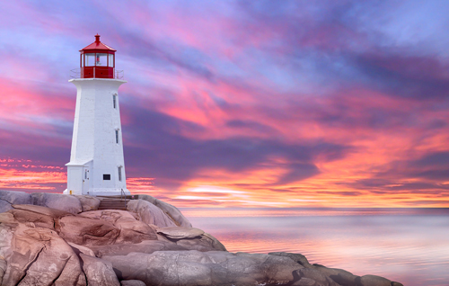 Peggy's Cove lighthouse in front of a pink sky, Canada