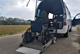 Adapted taxi van and wheelchair for travel in Barbados