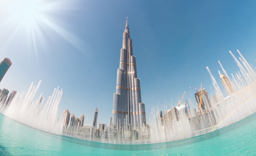 The Burj Khalifa amid tall buildings and fountains in Dubai, UAE