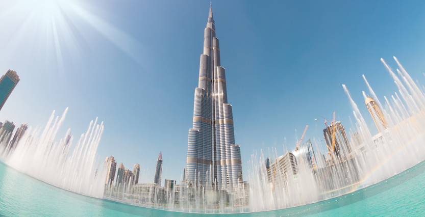 The Burj Khalifa and Dubai Fountain set against a clear blue sky, Dubai, UAE