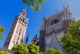 Seville Cathedral and Giralda tower against a blue sky in Seville, Spain