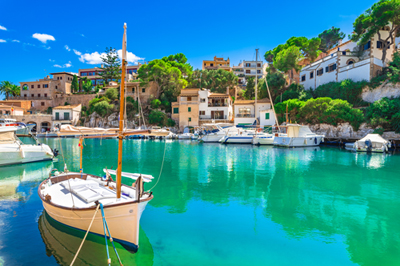 Boats on clear water in Santanyi Village Bay, Majorca, Spain