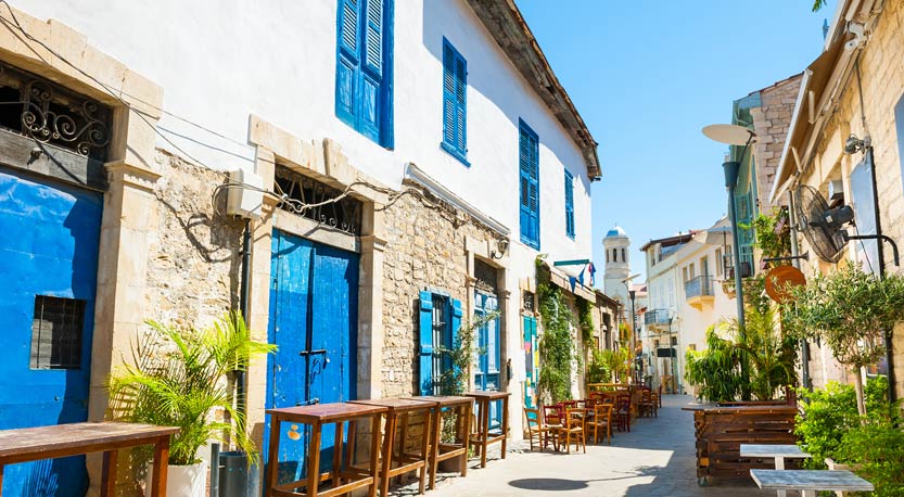 Sunny traditional street lined with plant life in Limassol, Cyprus