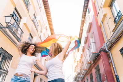 Lesbian couple in Madrid with Pride flag