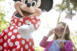 Girl and Minnie Mouse at Disney theme park